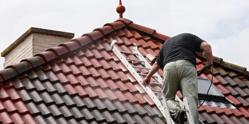 Roofer performing roof maintenance