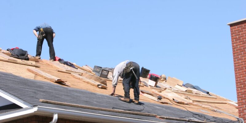 Roofers installing roofing materials