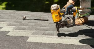 Roofer installing new shingles