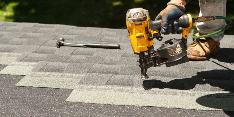 Roofer installing new shingles