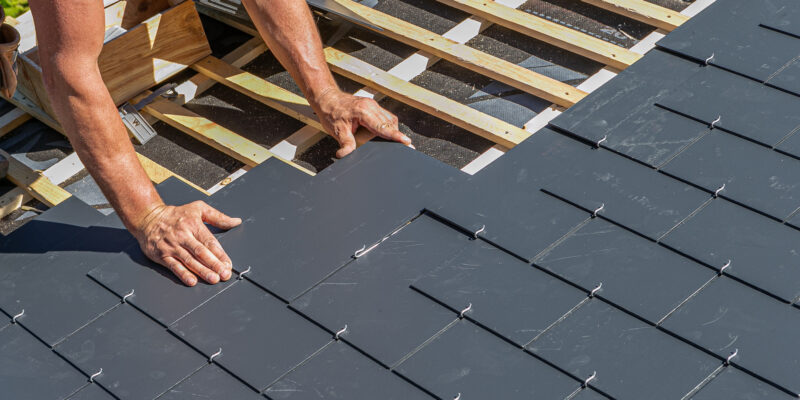 roof repair expert working on roof installation