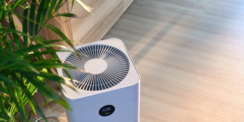Air purifier on wooden floor in comfortable home.