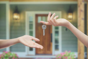 home sellers hand giving keys to home buyer
